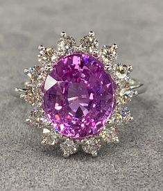 ALL THESE PHOTOS WERE TAKEN WITH AN ORDINARY IPHONE & HAVE NOT BEEN EDITED OR ENHANCED IN ANY WAY. Up for sale is a Stunning Natural Unheated Pink Sapphire & Diamond Halo Ring in solid 18K White Gold. This Ring was made by us Here in New York City & is of the Finest Quality.  The Center Stone is a Beautiful Natural GRS Certified 5.00 Ct Oval Cut Pink Sapphire that measures approx 11 x 9 mm, was mined in Madagascar & Has NOT Been Heated or Treated in Any Way. It has a very attractive Bright Pink Huge Rings, Beautiful Snakes, Future Engagement Rings, Diamond Halo Ring, Vs Diamond, Bling Rings, Halo Diamond Ring, Halo Ring, Diamond Halo