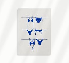 three blue bikinis hanging on clothesline against a white background with watercolor stains