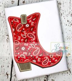 a red cowboy boot with paisley print on it