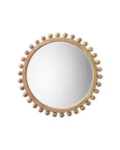 a round mirror with balls around it