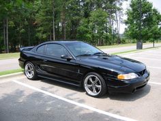 a black sports car parked in a parking lot