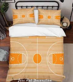 a bed with an orange basketball court on it and two pillows in front of it