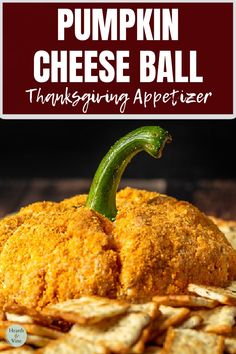 a pumpkin cheese ball sitting on top of a pile of crackers next to a sign that says, pumpkin cheese ball thanksgiving appetizer