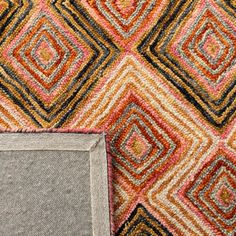 two different colored rugs with an empty square in the middle and one on the floor