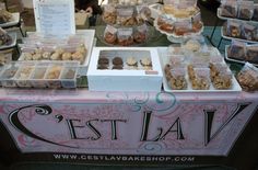 a table topped with lots of desserts and pastries next to a sign that says rest lav