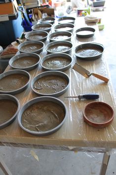 many pans are lined up on a table