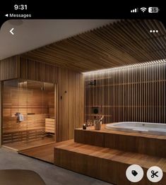 a bathroom with a jacuzzi tub next to a wooden wall and flooring