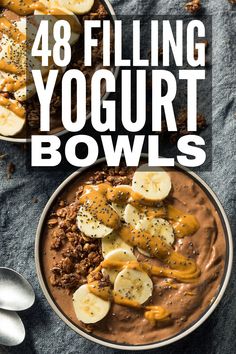 a bowl filled with chocolate pudding and bananas on top of a blue cloth next to spoons