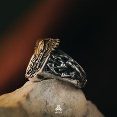 a silver ring sitting on top of a rock