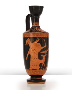 an old vase with the image of a man riding a horse on it's side