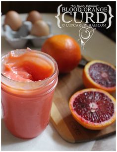 blood orange curd in a mason jar next to grapefruits