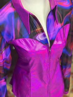 Blue, black, purple and pink patterned swirl print mesh top yoke and sleeves. The base, cuffs, and collar of this Kylee cut are made from a holographic orchid material for the perfect pairing! In stock and ready to ship in size XL with our Classic collar. Our fit will be your new favorite! Designed to automatically provide a custom feel, and flatter with a shaped bottom hem & princess seams cut from our 4-way stretch performance fabric. We also provide a generous bodice (no untucking problems, popping open, or restrictive feel) and extra sleeve length! Hand wash cold, lay flat to dry. Due to our made-to-order process, there may be slight variations of color and layout of the print, which create a unique & one-of-a-kind piece every time. Note: Made to order in the USA! In stock & ready to s Fitted Iridescent Tops, Purple Stretch Blouse For Party, Stretch Long Sleeve Disco Tops, Stretch Disco Tops With Long Sleeves, Purple Stretch Blouse For Night Out, Fitted Purple Long Sleeve Blouse, Fitted Long Sleeve Purple Blouse, Fitted Purple Blouse For Party, Fitted Purple Long Sleeve Tops