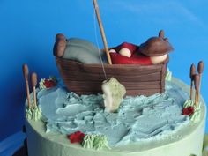 there is a cake that looks like a boat with two people in it