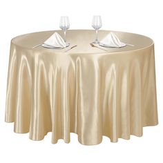 a round table with two wine glasses and napkins on it, sitting next to each other