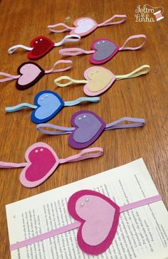 paper hearts are laid out on top of an open book