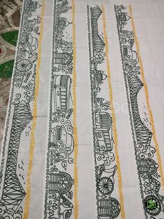 a table cloth with black and white designs on it's edges, along with yellow trimmings