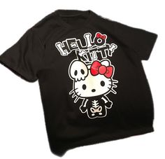 a black hello kitty t - shirt with a red bow on it