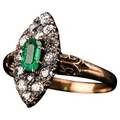 Welcome to Artisan Antiques based in Mayfair, London - We are delighted to offer this superb Victorian 18ct gold ring with an intricate navette design made c.1880. Distinctly Victorian and distinguished from contemporary pieces, this gorgeous piece presents one central 'emerald-cut' emerald encompassed by 14 old mine-cut diamonds (approx 0.45ct total) that glisten wonderfully under lighting. The central emerald has a desirable rich green hue with slight hints of brighter greens depending on the Victorian Emerald Ring In Yellow Gold, Victorian Yellow Gold Emerald Ring, Heirloom Marquise Rings With Intricate Design, Heirloom Marquise Ring With Intricate Design, Antique 14k Gold Marquise Ring, Antique Marquise 14k Gold Rings, Victorian 14k Gold Marquise Rings, Victorian Marquise 14k Gold Ring, Victorian Yellow Gold Marquise Cut Ring