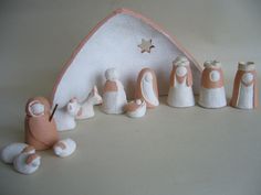 a nativity scene with figurines in pink and white