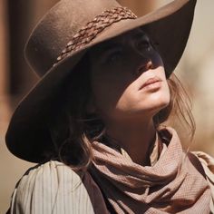 a woman wearing a brown hat and scarf