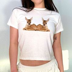 Fawn Deer Graphic 90s Baby Tee, Aesthetic Tee, Women's Fitted Tee, Unisex Shirt, Trendy Top, Y2K 90s Baby Tee, Gift For Her, Gift For Friend DETAILS - 100% cotton (fiber content may vary for different colors) - tear-away label  SIZING Sizes vary by shirt style. Please check the size chart before making your purchase. PLEASE NOTE: Our Baby tee is sized for a youth, reminiscent of the '90s-era shrunken-down T-shirt. This style, popularized by the skater/raver culture of the time, is not to be conf 90s Inspired White Tops With Funny Print, 90s Inspired White Top With Funny Print, 90s Inspired White Relaxed Fit Top, White Relaxed Fit Top Inspired By The 90s, Baby Tee Aesthetic, Deer Graphic, Fawn Deer, 2000s Tops, Fawns Deer