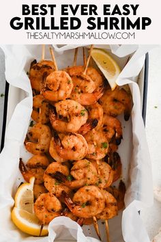 grilled shrimp skewers with lemon wedges and parsley on the side