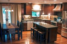 a large kitchen with wooden floors and stainless steel appliances in the center, along with dark wood cabinets