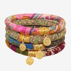 WHEN YOU WANT TO TELL A STORY WHAT IT IS: The most charming way to wear upcycled sari fabric bangles. WHY IT’S SPECIAL: These bangles were handmade for Rosena Sammi by women rescued from sex trafficking in India Every piece is unique—colors and patterns of the upcycled fabrics will vary Choose your vibe: peace; women supporting women; om, the protection of an evil eye GOOD TO KNOW: Diameter: 2.5" Due to their handmade nature, each piece is unique Gold Plated charms Choose your color: Bright: Can Charm Bangles, Blues And Greens, Sari Fabric, Charm Bangle, Bangles, Charms, Fabric