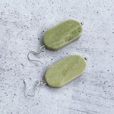 These unique earrings are the most beautiful chartreuse color and feature such interesting stones!  Silver fish hooks featuring thick chartreuse green oval shaped gemstones and measuring approximately 2.3 inches in total earring length.   When I saw these gemstones, I was instantly in love and you will be too :) Item is carefully packaged and shipped via USPS in a sturdy protective mailer. Check out more fabulous jewelry and enter my shop here: https://www.etsy.com/shop/jewelbytessyla View the p Green Oval Earrings With Natural Stones, Oval Green Earrings With Natural Stones, Handmade Oval Jade Earrings, Chartreuse Earrings, Feminine Earrings, Chartreuse Color, Chartreuse Green, Green Oval, Fish Hooks