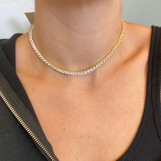 We took everyone’s favorite, the Tennis Choker, and enhanced the design. Adorn your neck with this gold-plated spectacular stunner. This sophisticated Tennis Choker is custom-cut in sleek crystal clear cubic zirconia 4mm stones. The delicate yet durable clasp fits perfectly on your collarbone because it comes in adjustable sizing. This tennis choker will take you everywhere from day to night. Designed to perfection in Montreal, Canada. All our products are of high quality, long-lasting, and resi Dazzling White Rhinestone Tennis Necklace, Dazzling Diamond White Rhinestone Tennis Necklace, Dazzling Diamond White Tennis Necklace With Rhinestones, Elegant Gold Tennis Necklace With Rhinestones, White Rhinestone Tennis Necklace, Luxury Cubic Zirconia Tennis Necklace With Rhinestones, Gold Crystal Tennis Necklace For Wedding, Gold Cubic Zirconia Tennis Necklace For Anniversary, Luxury Gold Diamond Tennis Necklace