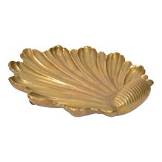 a gold leaf shaped dish on a white background