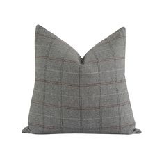 a gray and brown plaid pillow on a white background