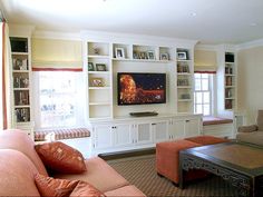 a living room filled with furniture and a flat screen tv