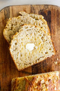 sliced loaf of banana bread with butter on top and two slices cut off the side