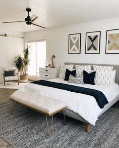 a bedroom with white walls and black accents