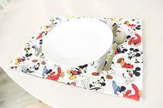 a mickey mouse place setting on a table