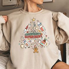 Welcome To My Store (*o▽o*) Have A Nice Day And A Wonderful Shopping Experience! Christmas ER Nurse Shirt, Christmas Tree Shirt,Xmas ER Crew Funny ER Ed Nurse Tech Shirt,Emergency Room Rn Tshirt,Emergency Department Gift ☘ UNISEX T-SHIRT MATERIALS 5.3 oz 100% preshrunk cotton. Sport Grey is 90% cotton, 10% polyester. MORE INFO Seamless collar, taped neck and shoulders. Double-needle sleeve and bottom hems. Quarter-turned to eliminate center crease. PRODUCTION AND SHIPPING ☘ Production: 1-3 busin Emergency Clothes, Er Nurse Shirt, Nurse Christmas Shirts, Nurse Shirts Vinyl Christmas, Er Nurse Christmas Shirts, Ed Nurse, Emergency Nurse Sweatshirt, Emergency Department, Er Nurse