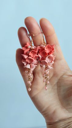 https://purplebeestudio.etsy.com Handmade unique polymer clay chandelier earrings in soft peach colour. These very elegant earrings will become your favorits for many occasions day or night. Perfect gift for a special woman in your life. Earrings made with brass ear wire. The earrings are very light and comfortable to wear all day. SHIPPING: Your order will be dispatched in a securely packed cardboard box. Product care:  - To ensure the product quality and durablility, avoid contact with water, lotion, perfumes and household cleaners and chemicals. - You can clean the products with a slightly damp soft fabric.  - Sharp objects can damage the clay surface. - When not in use, store in a dry, seperate box. Thank you for visiting my shop! If you have any special requests, I'll be happy to do m Handmade Blush Earrings As A Gift, Pink Clay Jewelry With Ear Wire, Pink Polymer Clay Jewelry For Weddings, Pink Polymer Clay Jewelry For Wedding, Handmade Elegant Apricot Earrings, Handmade Coral Earrings For Wedding, Elegant Pink Polymer Clay Jewelry, Clay Chandelier, Pink Polymer Clay Flower Earrings For Weddings