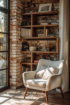 a chair sitting in front of a window next to a book shelf filled with books