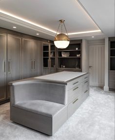 a large kitchen with an island in the middle and built - in cabinets on both sides