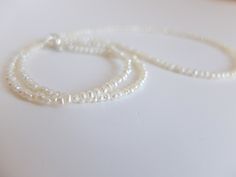 This necklace is made with creamy white tiny freshwater cultured pearls and it is finished with silver spring clasp. These are seed pearls and they measure 2 mm approximately , It's beautiful alone or together with other gemstone bracelet The length of the necklale is 44,00 cm inch 17.32 I can add a short extension chain at no extra cost Please note that you will receive the exact necklace shown in the photos above Questions or Comments are most welcome Thanks for stopping by. See my other handc White Pearl Beaded Necklace In Rondelle Shape, White Pearl Beaded Necklaces In Rondelle Shape, Delicate Tiny Beads Pearl Necklace For Wedding, Pearl White Necklace With Tiny Beads As Gift, Minimalist Pearl White Pearl Necklace With Tiny Beads, Delicate Pearl Necklace With Tiny Beads For Wedding, Minimalist Pearl White Necklace With Tiny Beads, White Rondelle Jewelry With Tiny Beads, White Rondelle Beaded Jewelry