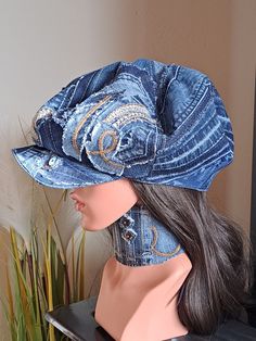 a mannequin's head wearing a denim hat on top of a table