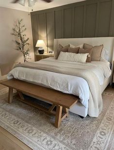 a bedroom with a large bed and wooden furniture