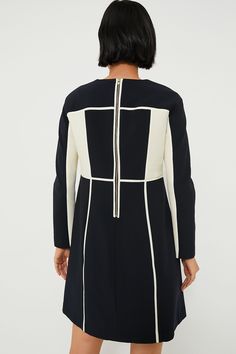 Cool colorblocking has never looked as chic as the Navy and Cream Evie Dress. Simple and timeless details like a round neckline and long sleeves combine with unique contrasting trim to create an intriguing effect that will have your friends asking where you got that fabulous frock! Throw on flats or slingbacks and grab your go-to purse for the perfect outfit formula suited for office days, ladies' luncheons, and cocktail hours. Round neckline Long sleeves Back zip closure Contrast trim detailing Long Sleeve Spliced Evening Dresses, Elegant Color Block Dresses, Chic Spliced Dresses For Work, Chic Long Sleeve Dresses With Contrast Color, Chic Long Sleeve Mini Dress With Splicing, Elegant Long Sleeve Mini Dress With Splicing, Classic Navy Tops With Contrast Trim, Chic Color Block Dress For Work, Elegant Contrast Color Block Dresses