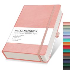 a pink colored notebook next to a stack of multicolored papers with the words rolled notebook written on it