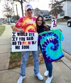 a man and woman holding up signs on the sidewalk