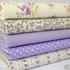 four different fabrics stacked on top of each other in purple, white and lavender colors