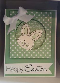 an easter card with a white bow on the front and green background, which says happy easter