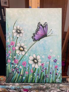 a painting of a purple butterfly flying over daisies on a blue sky with pink and white flowers