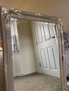 a large mirror sitting on top of a carpeted floor